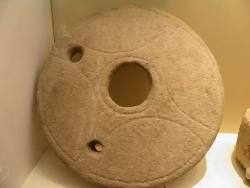 A cross on circular stone with a circle in the center